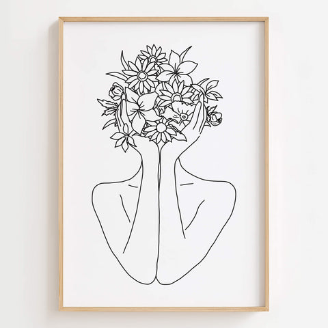 Floral Head Woman Line Art Print displayed in a modern living room with minimalist decor.