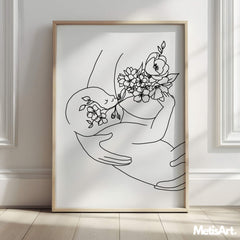 Close-up of monochrome line art featuring a mother and baby, surrounded by delicate floral accents.