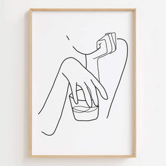 Woman Holding Whiskey Glass Art Print displayed in a sleek, modern bar area.