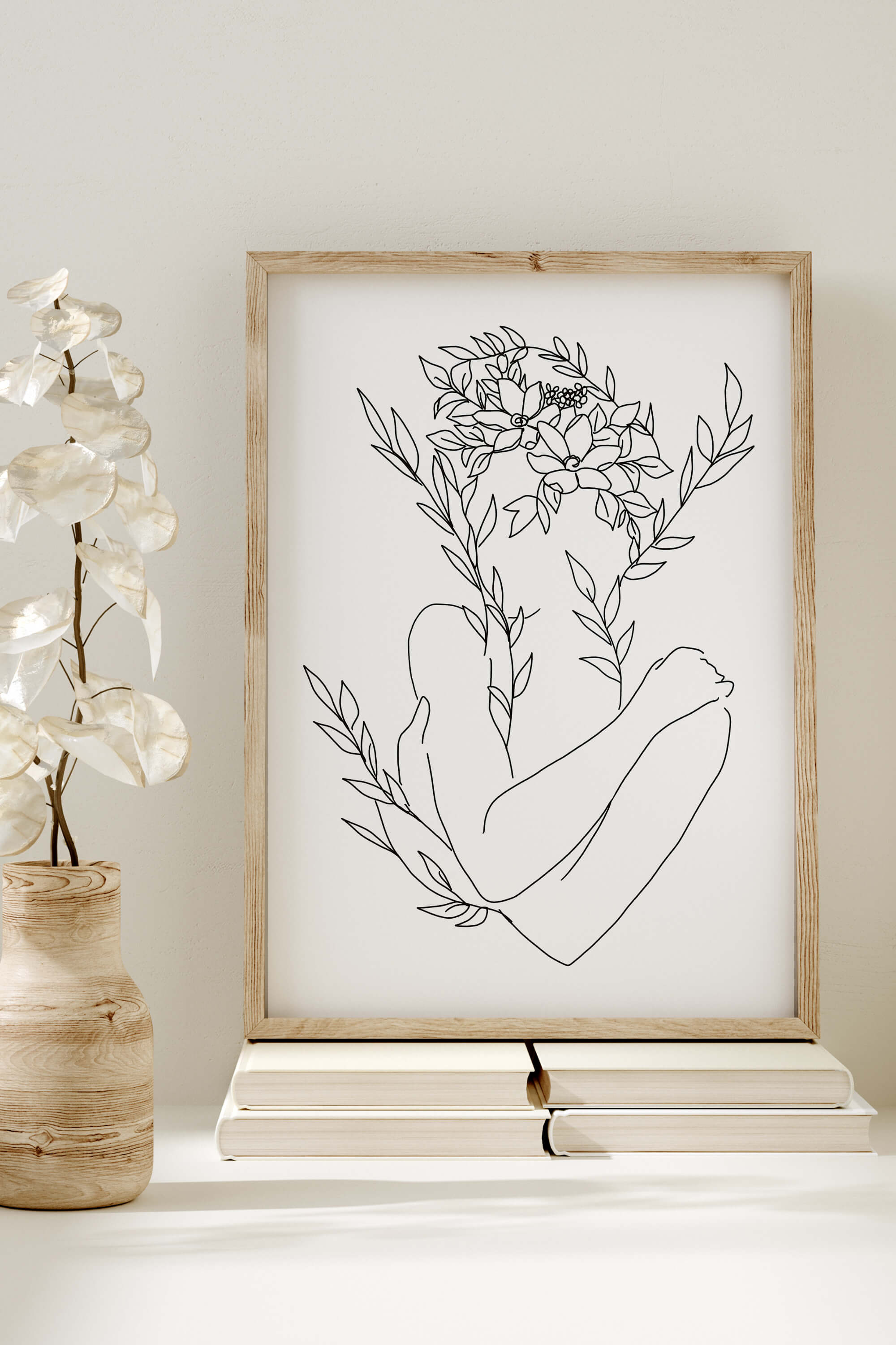 Discover the charm of line art and the beauty of greenery in this bedroom decor piece. Each stroke tells a story of the human body adorned with floral elements, creating a powerful and serene ambiance. Immerse yourself in the allure of monochrome sophistication.