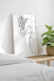 Botanical wall art with a floral abstract theme for the bedroom. This art print features delicate flowers, adding a touch of nature's elegance to your living space. The minimalist design and versatile style make it a standout piece.
