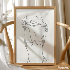 Black-and-white empower women art hanging in a bathroom, promoting confidence and empowerment.