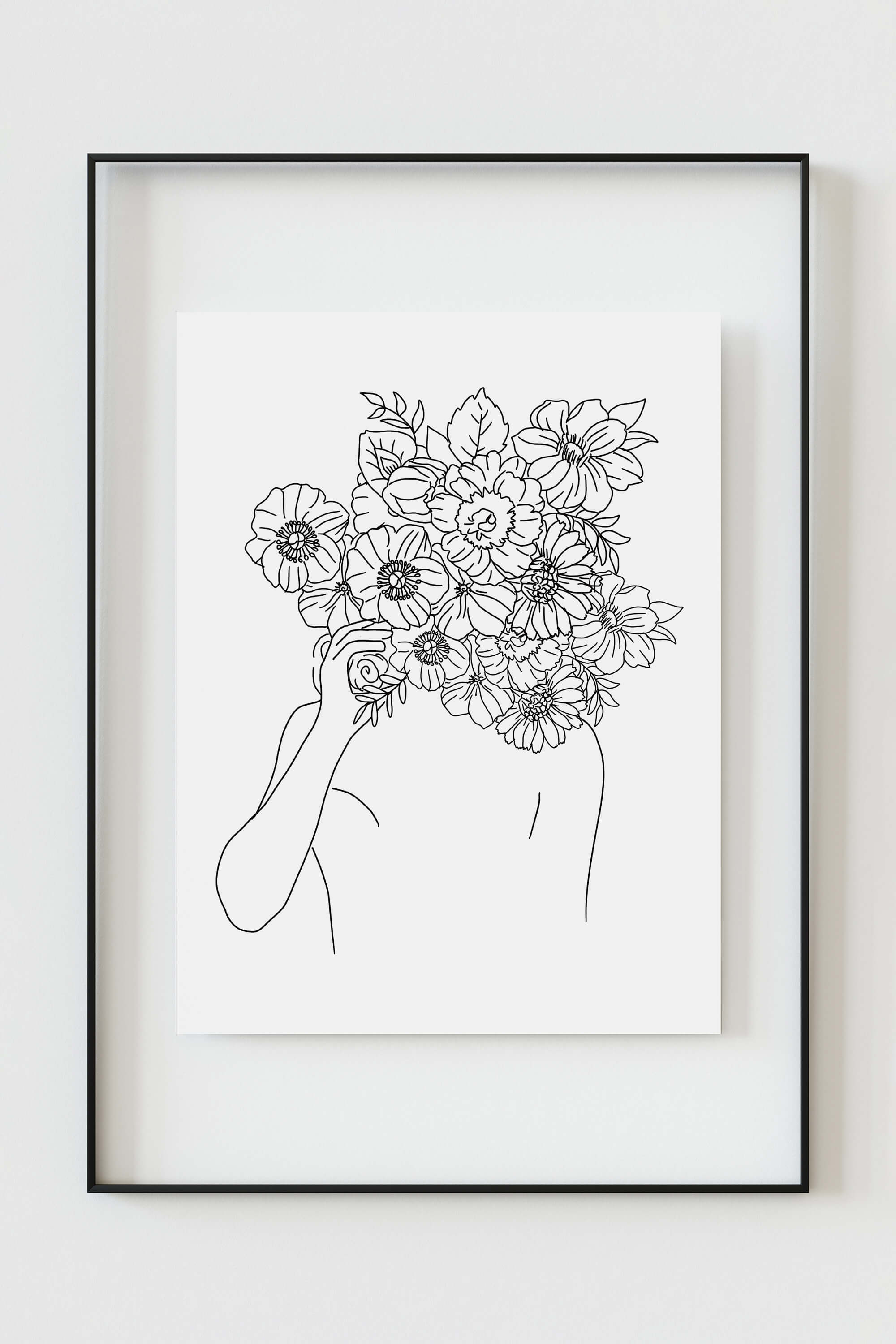 A boho-chic wall art piece depicting a feminine face with intricate flower details – a captivating illustration in black and white, bringing a touch of nature to your space.