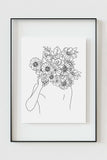 A boho-chic wall art piece depicting a feminine face with intricate flower details – a captivating illustration in black and white, bringing a touch of nature to your space.