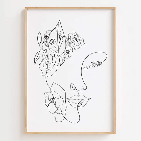 Floral Woman Face Portrait Line Art Print displayed in a modern living room, adding nature-inspired elegance to the space.