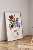 Glamour and confidence embodied in a line art print with a woman's red-lipped portrait and floral adornment.