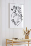 Botanical art print of a couple holding hands over a heart. The print reflects the beauty and diversity of nature in a realistic and detailed style. The print is a tribute to interconnected couples.
