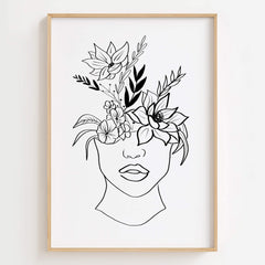 Modern minimalist black line art print of a woman's face with an elaborate floral design on her head, in a wooden frame.