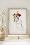 Nature-inspired line art decor featuring a woman with a bouquet, blending tranquility with home aesthetics.