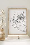 A monochromatic masterpiece portraying the beauty of motherhood, blending cultural symbols with botanical elements, offering a unique and meaningful addition to your art collection.