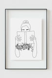 Sophisticated wall art of an elegant woman reading a book surrounded by delicate floral details. This captivating black and white line art enhances any space, making it an ideal gift for literature enthusiasts.