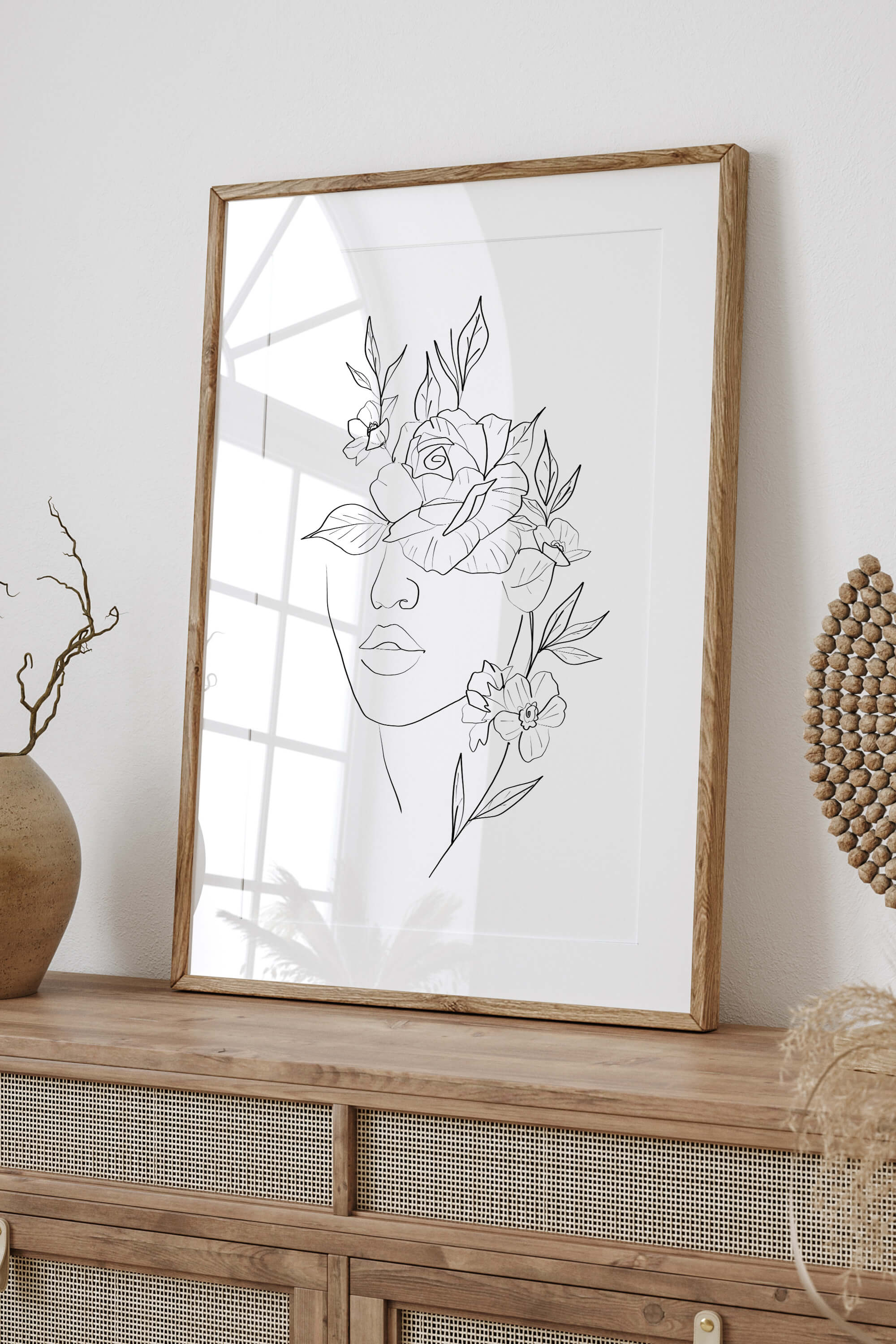 Discover the boho chic bliss of this artwork, featuring a woman's face intertwined with roses, creating a captivating and culturally inspired piece that adds a touch of individuality to your space.