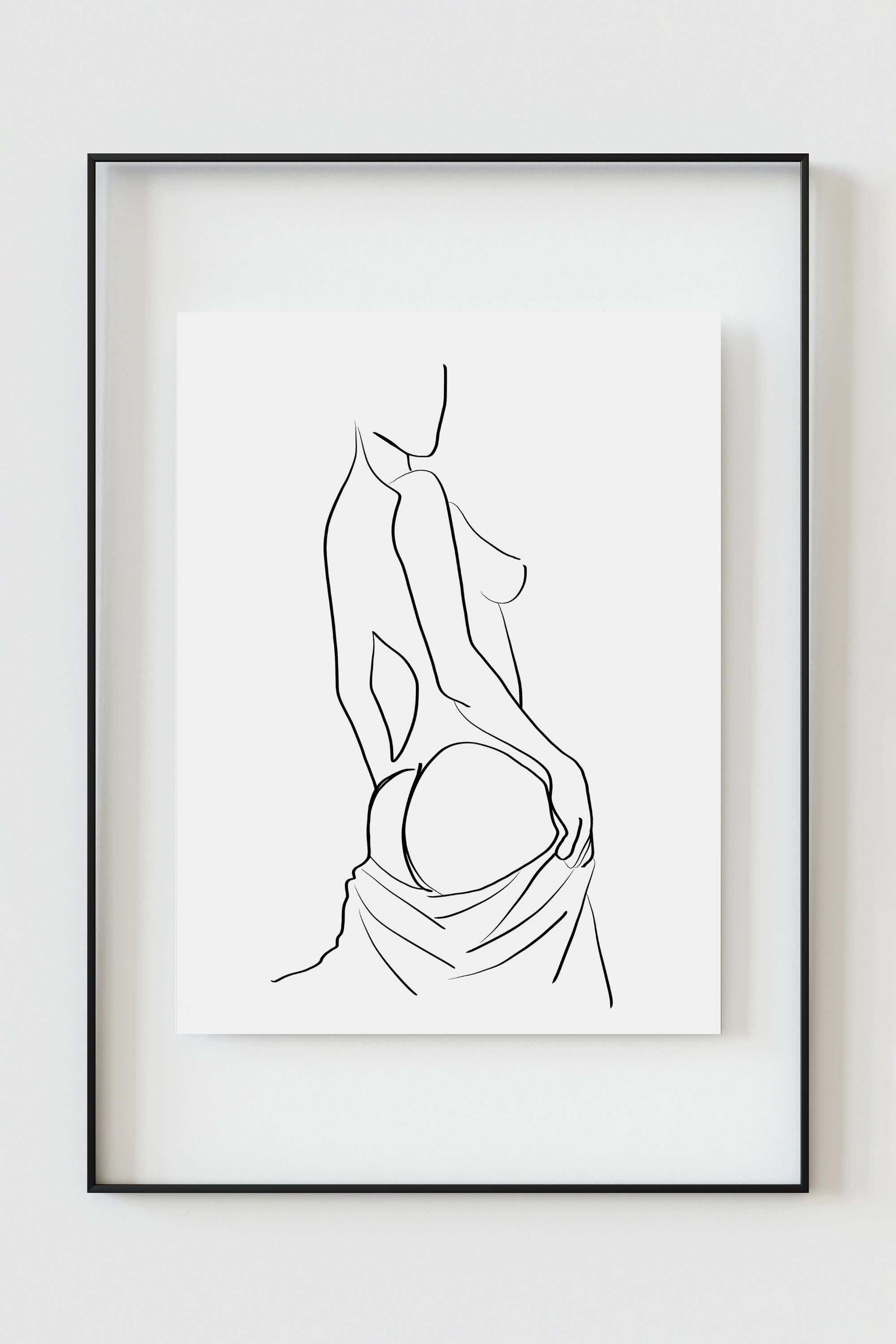 Exquisite line art print capturing the sensual allure of a woman's back. The play of light and shadow in this black and white masterpiece adds a touch of mystery and sophistication to your living space.