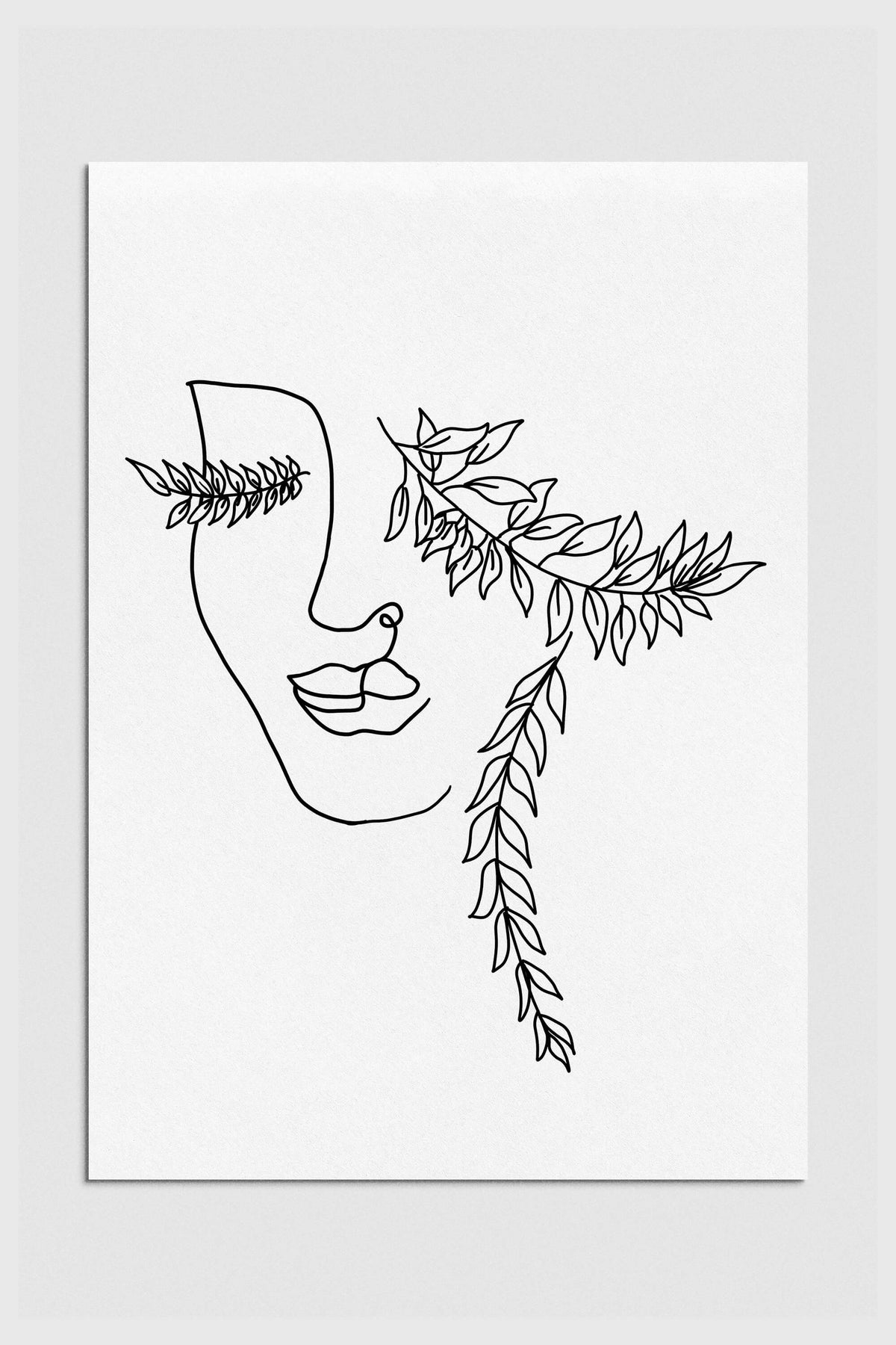 Black and white line art depicting a serene female face with botanical elements, adding elegance to your space. Nature-inspired boho wall art with a focus on feminine beauty.